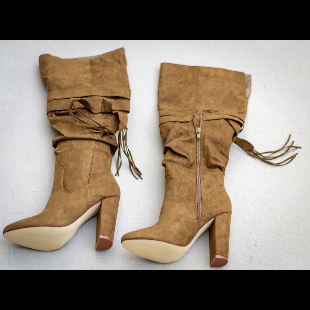 Heeled tan boots new in box. Never worn